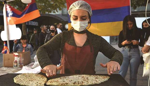 Refugees who fled the breakaway Nagorno-Karabakh region due to the ongoing military conflict between Armenia and Azerbaijan over the disputed region, make jingalov hats u2013 traditional Karabakh flatbreads stuffed with greens u2013 for sale in Yerevan. The money raised would be sent to Karabakh.