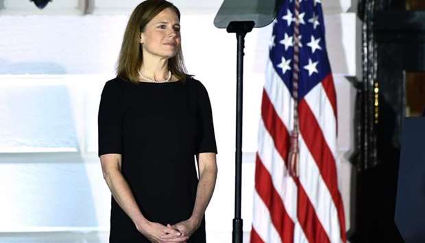 Judge Amy Coney Barrett looks on before being sworn in as a US Supreme Court Associate Justice during a ceremony on the South Lawn of the White House