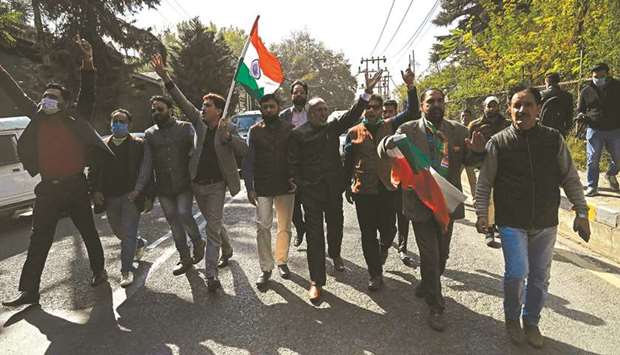 Bharatiya Janata Party (BJP) activists wave a national flag during a demonstration outside the residence of former chief minister and Peoplesu2019 Democratic Party president (PDP) Mehbooba Mufti in Srinagar yesterday following her remarks that she will hoist the Indian flag only when J&Ku2019s flag is returned to the state.