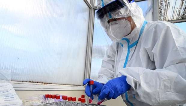 A medical staff manipulates sample tests for Covid-19 at a drive-through testing site on October 26 in Zagreb, Croatia