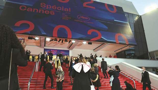Guests arrive yesterday at the Palais des Festivals et des Congres ahead of Cannes 2020 Special, a mini-version of the Cannes Film Festival, in Cannes, southeastern France. Cannes 2020 Special, held amid the coronavirus pandemic after the 73rd edition of the Cannes Film Festival scheduled for May 2020 was cancelled, opened yesterday and ends tomorrow.