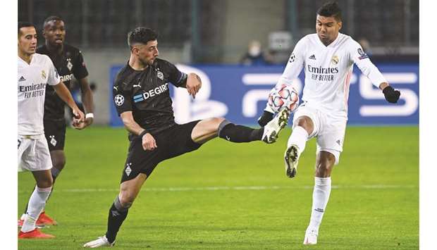 Real Madridu2019s Casemiro (right) and Moenchengladbachu2019s Lars Stindl vie for the ball during the Champions League group B match on Tuesday. (AFP)