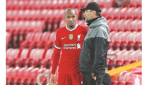 Liverpoolu2019s midfielder Fabinho (left) speaks to manager Jurgen Klopp after picking up an injury during the UEFA Champions league match against Midtjylland on Tuesday. (AFP)