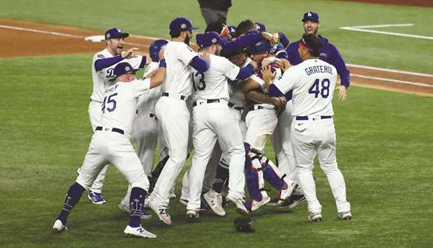 Los Angeles Dodgers players celebrate winning the World Series against the Tampa Bay Rays after game six of the 2020 World Series at Globe Life Field in Arlington, Texas, USA. (USA TODAY Sports)