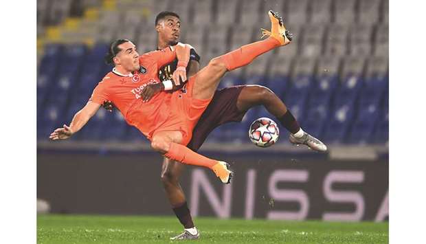 Istanbul Basaksehiru2019s French forward Enzo Crivelli (L) fights for the ball with Paris Saint-Germainu2019s French defender Presnel Kimpembe during their UEFA Champions League Group H match at the Basaksehir Fatih Terim stadium in Istanbul yesterday.