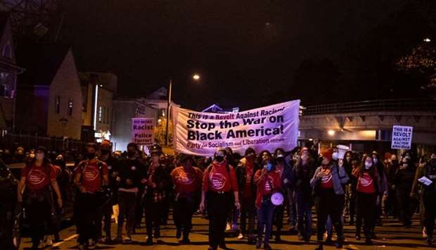 Protesters march through West Philadelphia on October 27, during a demonstration against the fatal shooting of 27-year-old Walter Wallace, a Black man, by police