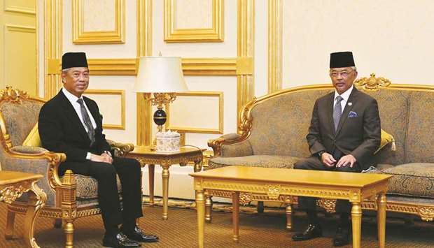 Malaysia Prime Minister Muhyiddin Yassin (left) posing for pictures with Malaysiau2019s King Sultan Abdullah Sultan Ahmad Shah prior to their meeting at the National Palace in Kuala Lumpur.