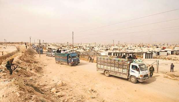 A convoy of trucks transporting Syrian women and children suspected of being related to Islamic State (IS) group leaves the Al-Hol camp, after being released to return to their homes, in the Al-Hasakeh governorate in northeastern Syria, yesterday.