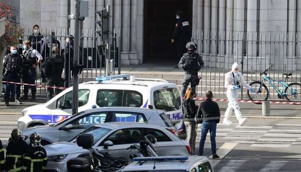 French members of the elite tactical police unit RAID enter to search the Basilica of Notre-Dame de Nice after a knife attack in Nice
