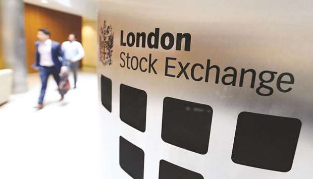 Visitors pass a sign inside the main atrium of the London Stock Exchange Group headquarters. The FTSE 100 closed less than 0.1% down at 5,581.75 points yesterday.