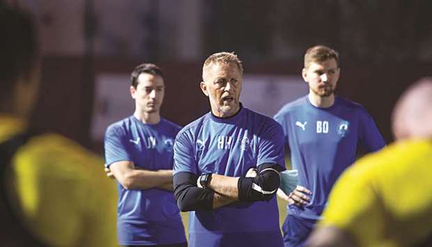 Al Arabi coach Heimir Hallgrimsson (centre) speaks to his players during a training session yesterday.