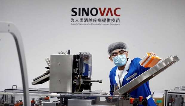 A man works in the packaging facility of Chinese vaccine maker Sinovac Biotech, developing an experimental coronavirus disease vaccine, during a government-organized media tour in Beijing, China, September 24