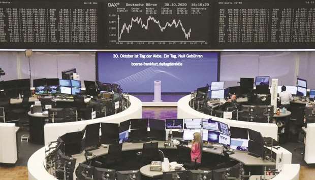 Traders work at the Frankfurt Stock Exchange. The DAX 30 closed down 0.4% to 11,556.48 points yesterday.