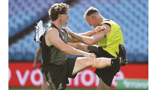 Australiau2019s captain Michael Hooper (L) and Reece Hodge attend the captainu2019s run training session in Sydney yesterday.