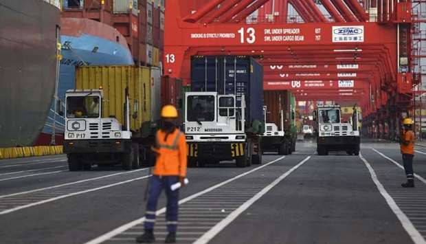 Sri Lankan authorities load containers of garbage, allegedly including hospital waste, to be taken back to Britain, from where they had been sent illegally to Sri Lanka, in Colombo yesterday.