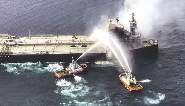 In this handout file photograph taken on September 4, 2020, and released by Sri Lankau2019s Air Force shows fireboats battling to extinguish a fire on the Panamanian-registered crude oil tanker New Diamond.