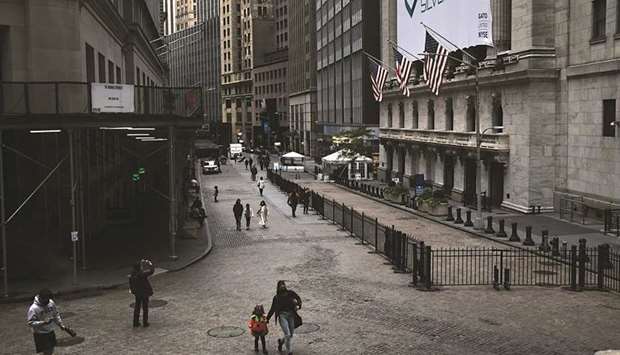 People walk by the New York Stock Exchange. Some investors are betting the technology and communications stocks that drove a massive rebound in US markets this year will face a tougher slog in coming months, no matter whether Republican President Donald Trump or Democratic challenger Joe Biden wins Tuesdayu2019s election.