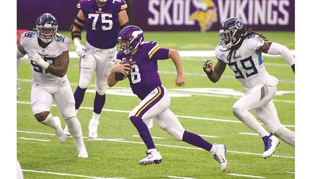 Minnesota Vikings quarterback Kirk Cousins scrambles in the fourth quarter against the Tennessee Titans at US Bank Stadium in Minneapolis. (USA TODAY Sports)