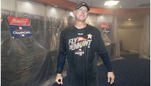 In this file photo taken on October 20, 2017, AJ Hinch of the Houston Astros celebrates in the locker room after defeating the New York Yankees by a score of 4-0 to win Game Seven of the American League Championship Series at Minute Maid Park in Houston, Texas.  (AFP)
