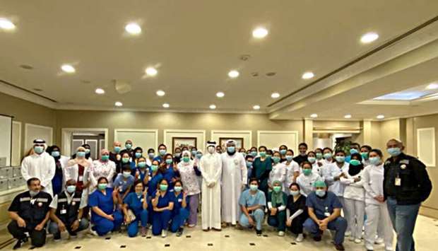 Qatar Care staff with officials: Providing exemplary voluntary service