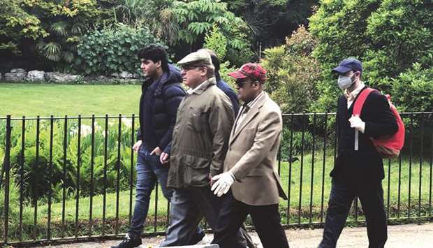Out and about: Former prime minister and PML-N supremo Nawaz Sharif, centre, seen at a park in London in this undated file photo.
