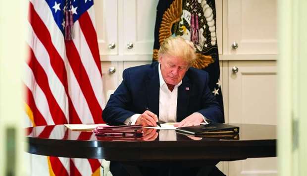 This White House handout photo released Sunday shows Trump working in the Presidential Suite at Walter Reed National Military Medical Center in Bethesda, Maryland on October 3, after testing positive for Covid-19.