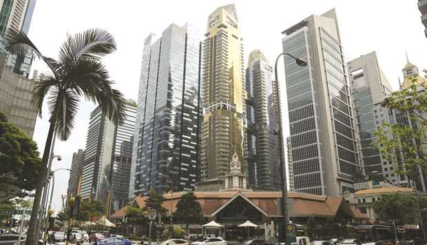 Buildings stand in the central business district in Singapore. Banks will extend debt relief for individuals and small-to-midsized businesses beyond the end of the year to support borrowers hardest hit by the coronavirus pandemic.