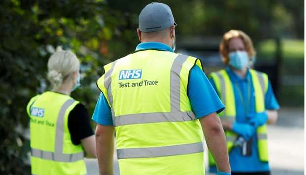 NHS Test and Trace workers are seen at a test station in Richmond-Upon-Thames, Britain, September 15. REUTERS
