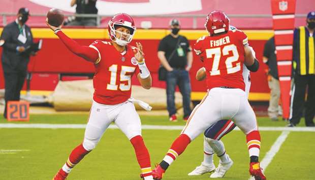 Kansas City Chiefs quarterback Patrick Mahomes (left) throws a pass against the New England Patriots during the first quarter of a NFL game at the Arrowhead Stadium in Kansas City, Missouri, USA. (USA TODAY Sports)