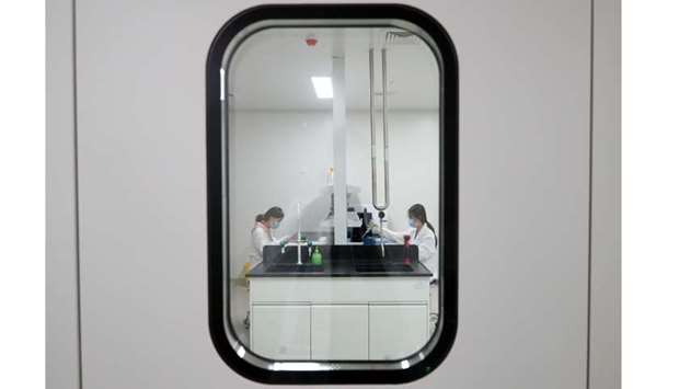 Women work in a laboratory of Chinese vaccine maker Sinovac Biotech, developing an experimental coronavirus disease vaccine, during a government-organized media tour in Beijing, China, September 24.
