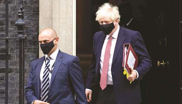 Prime Minister Boris Johnson, wearing a face covering due to the Covid-19 pandemic, leaves 10 Downing Street in central London yesterday, to attend the weekly session of Prime Ministeru2019s Questions at the House Commons.