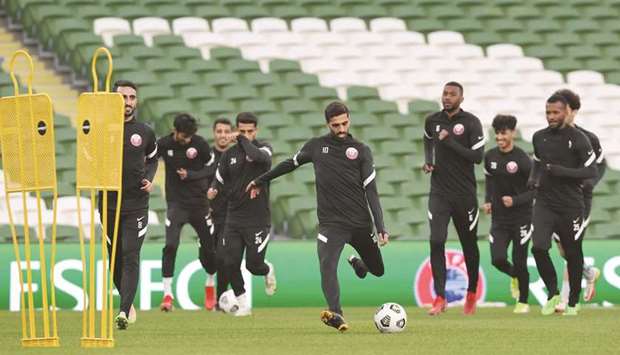 Qatar captain Hassan al-Haydos (centre) trains with his teammates in Dublin yesterday.