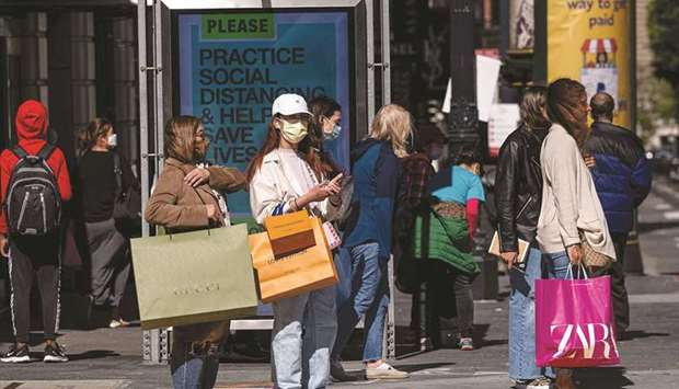 People carry shopping bags while waiting to cross Geary Street in San Francisco. US consumer prices increased solidly in September and are poised to rise further in the months ahead amid a surge in the costs of energy products, which would cast doubts on the Federal Reserveu2019s view that high inflation is transitory.