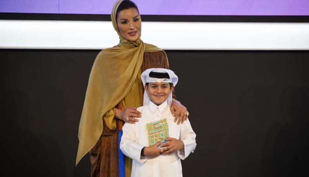 QF chairperson Her Highness Sheikha Moza bint Nasser with a winner of the Akhlaquna Award. Credit Aisha al-Musallam.