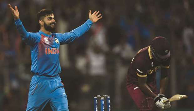 In this file photo taken on March 31, 2016, Indiau2019s Virat Kohli celebrates after taking the wicket of West Indiesu2019s Johnson Charles during the World T20 semi-final at The Wankhede Cricket Stadium in Mumbai. (AFP)