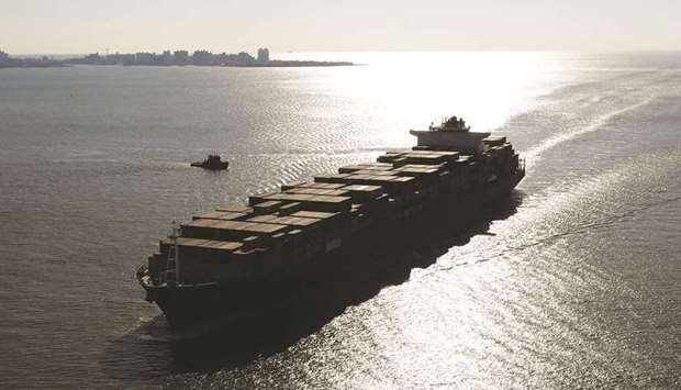 A container ship sails into New York Harbor (file).