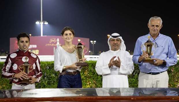 QREC Racing Manager (second right) Abdulla Rashid al-Kubaisi with the winners of the Al Hamla Cup, the feature race of the seasonu2019s second meeting at Al Rayyan Racecourse on Thursday.
