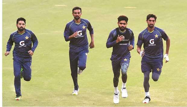 Pakistanu2019s captain Babar Azam (second right) runs with teammates during a team practice session at the Gaddafi Cricket Stadium in Lahore yesterday. (AFP)