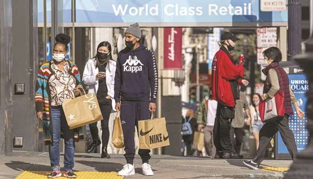 Pedestrians carry shopping bags in San Francisco. US retail sales unexpectedly rose in September, boosted in part by a jump in receipts at auto dealerships due to higher motor vehicle prices, but there are fears that supply constraints could disrupt the holiday shopping season amid continued shortages of goods.