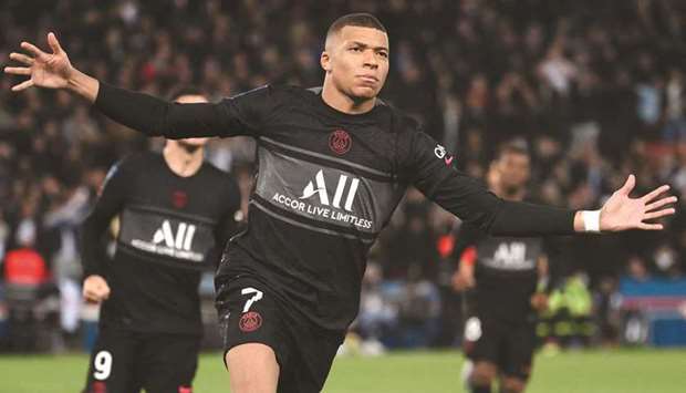 Paris Saint-Germainu2019s French forward Kylian Mbappe celebrates after scoring a penalty during the French L1 match against SCO Angers at the Parc des Princes Stadium in Paris yesterday. (AFP)