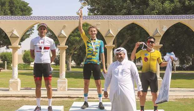 Winner Bilal al-Saadi (second left), runner-up Mouhcine Rhaili (left) and third-placed Jamison Carino (right) pose with a Qatar Cycling Federation after the Dukhan Climberu2019s Race on Friday.