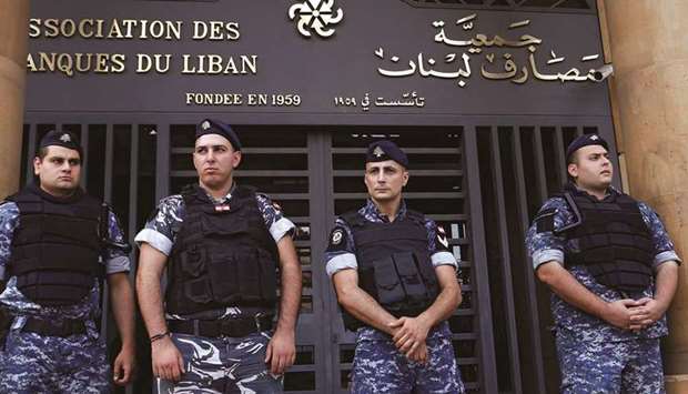Lebanese police stand outside the entrance to the office of Association of Banks in downtown Beirut (file). Nearly 80% of Lebanonu2019s population lives below the poverty line.