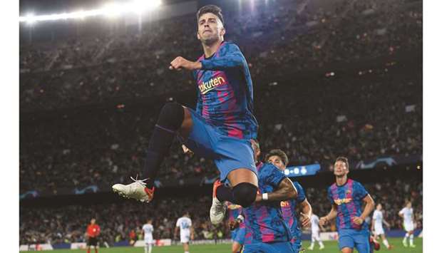 Barcelonau2019s Spanish defender Gerard Pique celebrates after scoring a goal during the UEFA Champions League Group E match against Dynamo Kyiv at the Camp Nou Stadium in Barcelona yesterday. (AFP)