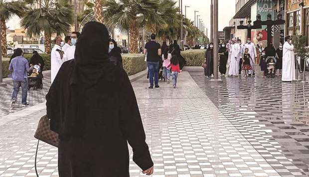 People walk along a promenade outside a shopping centre in Riyadh (file). Saudi Arabia, the worldu2019s largest crude oil exporter, will see 5.1% economic growth next year after a modest 2.3% expansion this year and a sharp 4.1% contraction last year, according to the Reuters poll.