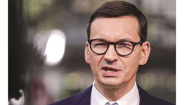 Polandu2019s Prime Minister Mateusz Morawiecki addresses media representatives as he arrives on the the first day of a European Union (EU) summit at The European Council Building in Brussels, yesterday.