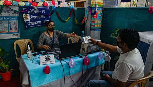 A health worker (L) registers a man for a dose of the Covaxin vaccine against the Covid-19 coronavirus at a health centre in New Delhi.