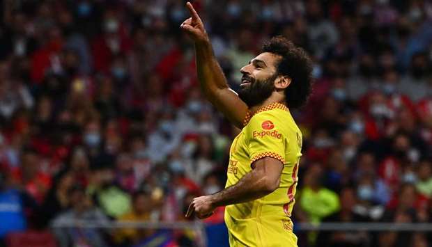 Liverpool's Egyptian forward Mohamed Salah celebrates after scoring his team's third goal during the UEFA Champions League Group B football match.