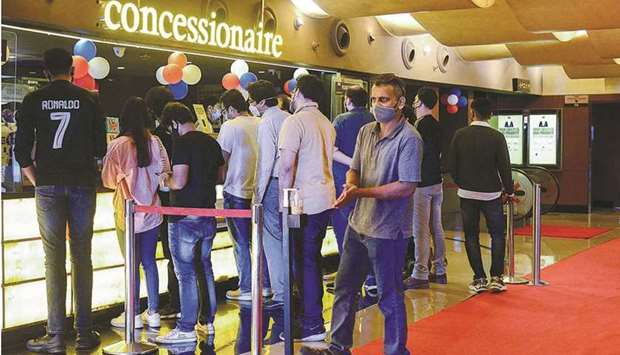 Cinema-goers queue up to buy snacks during intermission time at a cinema theatre in Mumbai yesterday.