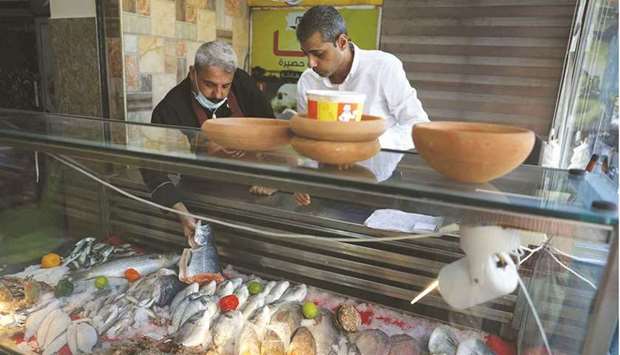 Moeen (left) and Mustapha Abu Hassira display fresh fish at Roma fish restaurant owned by the Abu Hasira family in Gaza City.