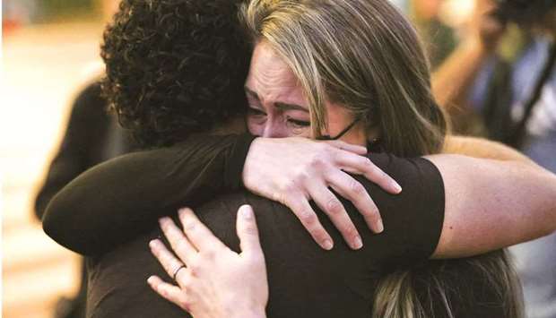 Members of the local film community mourn the loss of cinematographer Halyna Hutchins, who died after being shot by Alec Baldwin on the set of his movie Rust at a vigil in Albuquerque, New Mexico.  (Reuters)